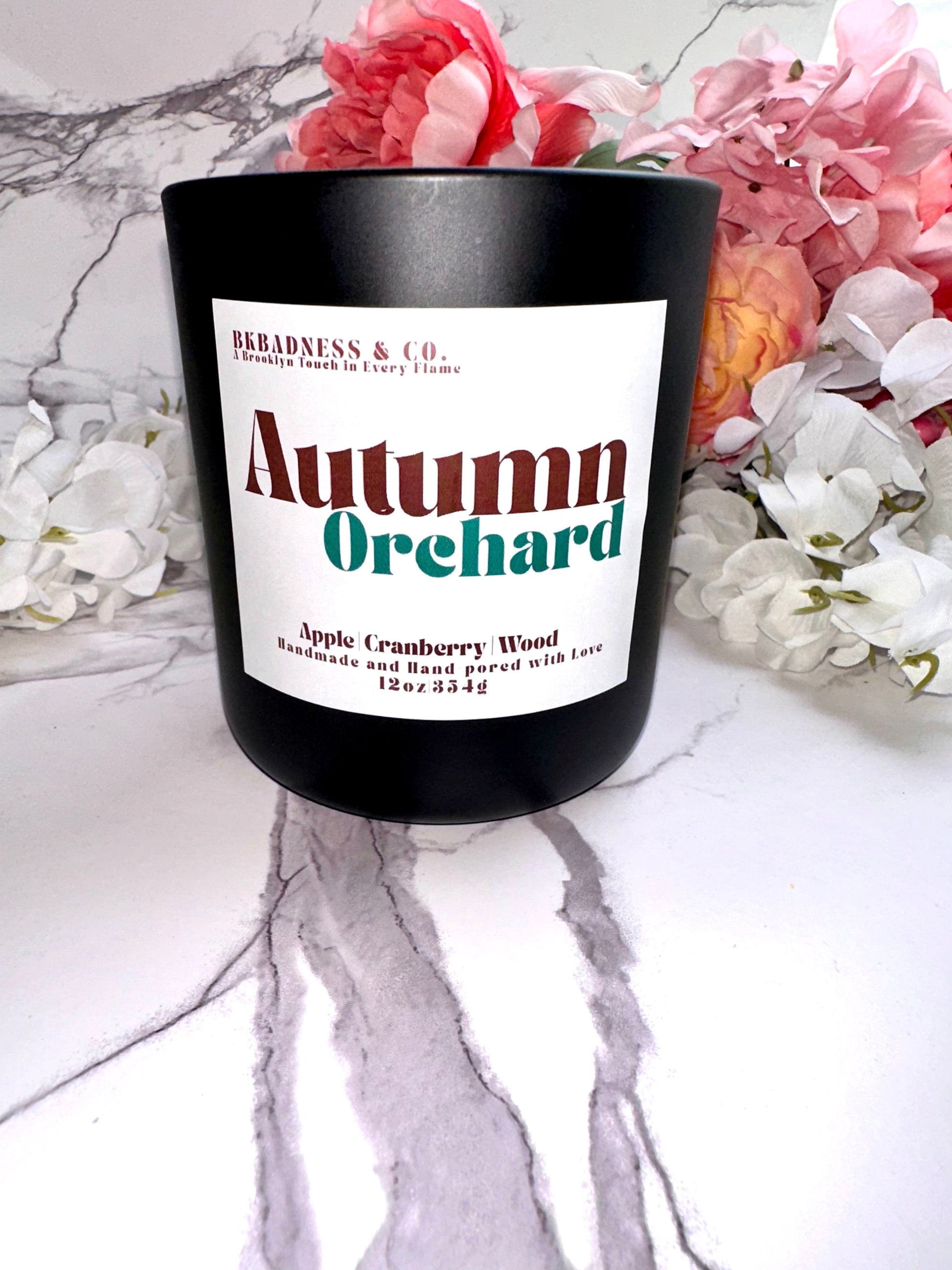 Candle labeled 'Autumn Orchard' with floral background