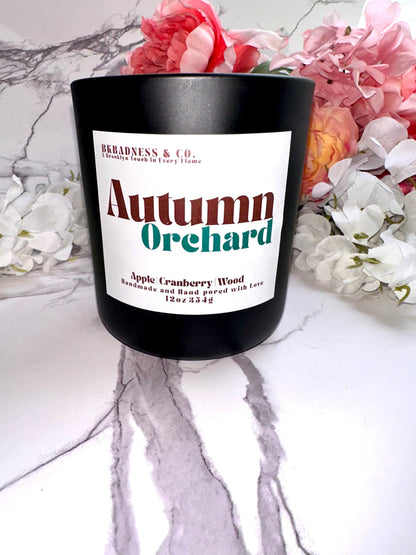 Candle labeled 'Autumn Orchard' with floral background